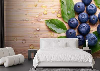 Blueberry fruit with leaf with waterdrops over wooden background Wall mural