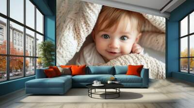 Cute little baby hikding under a blanket Wall mural