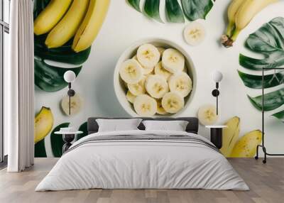 Fresh sliced banana fruit in a bowl on wooden table closeup view Wall mural