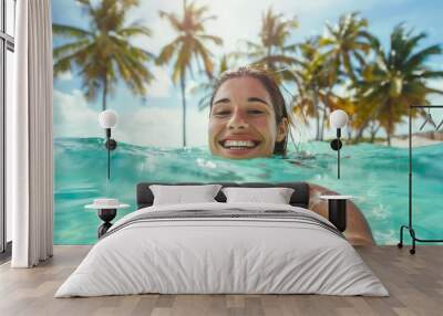 Portrait of a smiling female swimmer in water in pool Wall mural