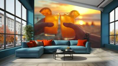 Two glasses of orange juice clink with tropical sea and sunset romantic background Wall mural