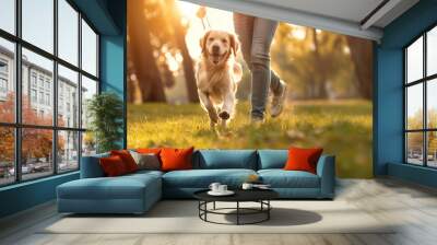 Cute golden retriever dog running with owner in sunny park. Pet-friendly lifestyle Wall mural