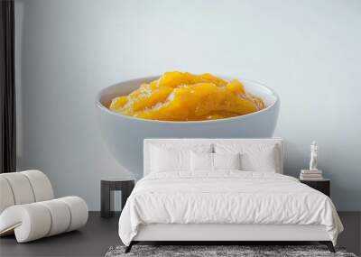 A bowl of mango chutney, set against a plain white backdrop. Wall mural