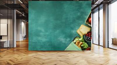 A green background with a lunch bag and lunchbox, filled with yummy food. There's room to add some text. Wall mural