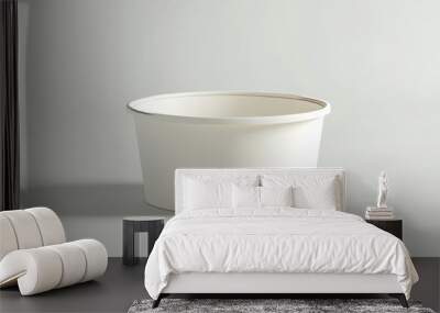 A realistic empty paper bowl or container is positioned alone on a plain white background. This is useful for product packaging design presentations and online advertising. Wall mural