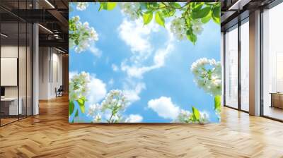 Blue sky with white flowers and leafy green decoration Wall mural