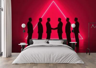 Six silhouetted men shake hands beneath a glowing triangular neon backdrop, evoking themes of connection, business, and modernity. Wall mural