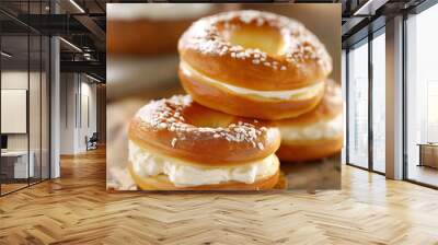 stack of three bagel with cream filling on a wooden table Wall mural