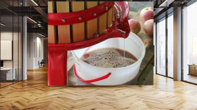 Pressing Autumn Apples with a Cider Press to Make Homemade Apple Cider Wall mural