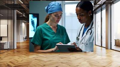 Two Diverse Doctors Reviewing Medical Records on Tablet Wall mural