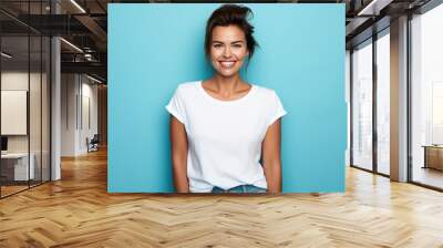 Close up of a young adult 30s age woman smiling and wearing a white t-shirt on a turquoise background. Healthy face skin care beauty, skincare cosmetics, dental. Wall mural