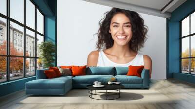 Closeup photo portrait of a beautiful young latin hispanic model woman smiling with clean teeth. Used for a dental ad. Isolated on light background. Wall mural