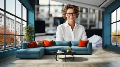 Woman in white shirt leaning on desk. Female accountant working with stack of papers, searching information, analyst business report. Businesswoman with paperwork in modern office. Wall mural