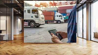 The business team using a tablet to track cargo movement and manage shipping logistics.  Wall mural