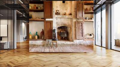 Interior of old house in Georgia country, with kitchen utensils, kettle, primus, fireplace and wooden floor Wall mural