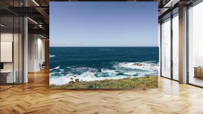 Blue view of North sea from Spanish coast with hitting white waves  Wall mural