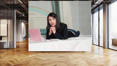 woman lying on the bed with laptop Wall mural