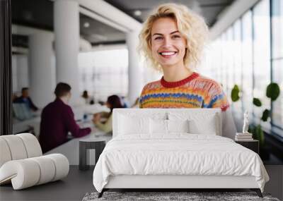 Professional woman standing in her office while looking at camera and smiling Wall mural