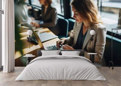 Shot of pretty happy young entrepreneur woman working with laptop sitting in the office. Wall mural