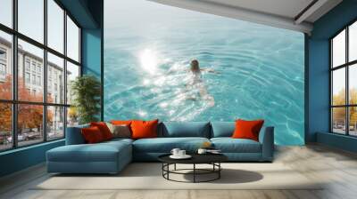 Happy woman enjoying the sun and water at the pool. Lifestyle and summer concept Wall mural