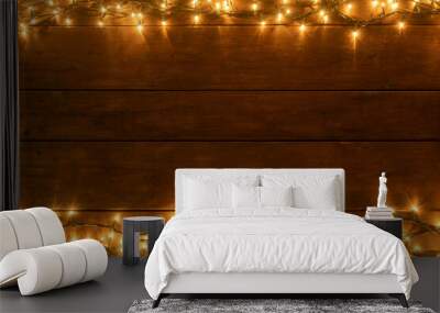 BROWN WOODEN PLANK AND WARM LIGHTS ABOVE AND BELOW. COPY SPACE FOR TEXT. RUSTIC CHRISTMAS ADVERTISEMENT CONCEPT Wall mural