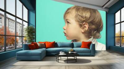 Lovely little girl on a blue background .Little girl in profile Wall mural