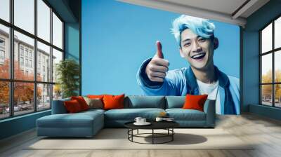 smiling young asian in stylish blue attire gestures in a lively, clean atmosphere. Wall mural