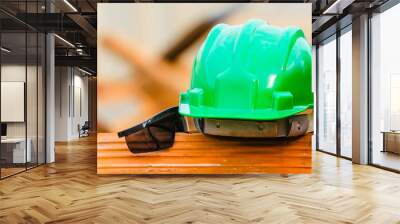 Green helmet and goggles under construction in Brazil. Concept of safety, individual protection equipment Wall mural