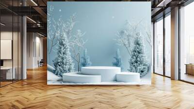 winter-themed scenario with three white podiums for product presentation, trees with snow on the bac Wall mural