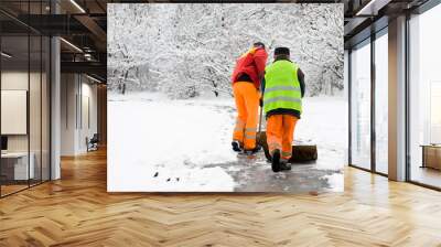 unidentified workers removing first snow from pavement Wall mural