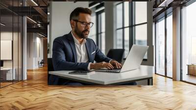 a man is working on his laptop in the office. work in office Wall mural