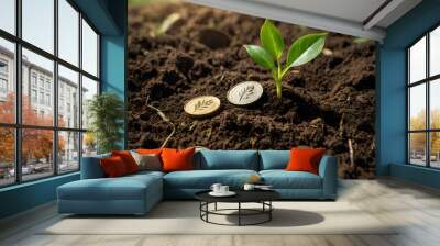 a small plant growing on a coin lying on the ground. Green investment concept, Collecting money to invest. Financial growth concept Wall mural