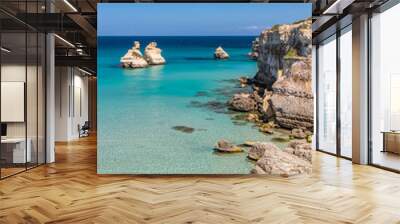 The bay of Torre dell'Orso, with its high cliffs, in Salento, Puglia, Italy. Turquoise sea and blue sky, sunny day in summer. A beach of fine white and pink sand. The stacks called the Two Sisters. Wall mural