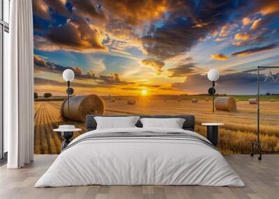 Sunset over a field with hay bales Wall mural