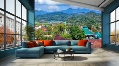 high angle view of the Indonesian city (Sumedang) or buildings and houses on the edge of the mountain seen from the top of the building with a beautiful sky and clouds in the background Wall mural