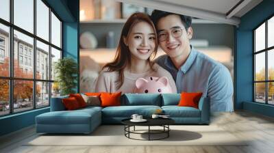 Happy asian family young couple love hand holding piggy bank to save and model house for saving money wealth to buy real estate for new home. Financial planning, business finance, Generative AI Wall mural