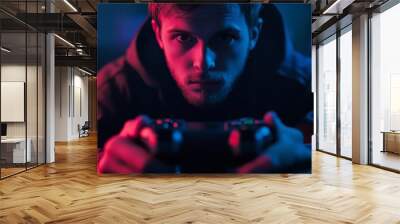 A Man Holding a Game Controller. A Young Man Playing Video Games Wall mural