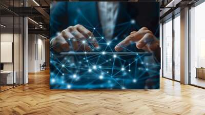 Businessman using a tablet and touching a digital connection network on a dark blue background, a close up of a hand holding a tablet with global connections or data transfer technology concept Wall mural