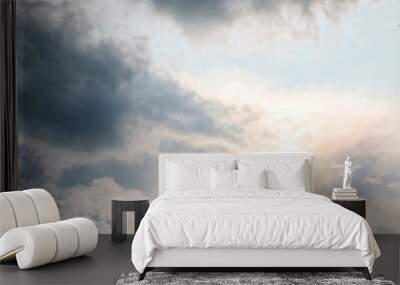 Beautiful sunny cloudscape in pastel colors of blue, white and yellow. Wall mural