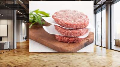 Raw burgers stacked with salad Wall mural