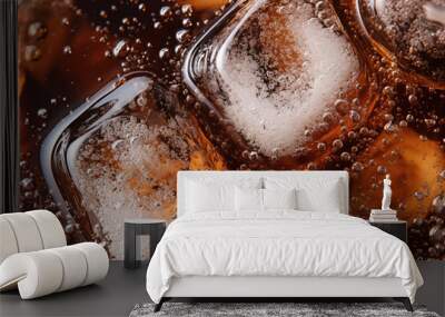 Close-up shot of Soda bubbles in a cola with ice in glass Wall mural