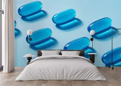 Blue capsules on a plain blue background with soft shadows Wall mural