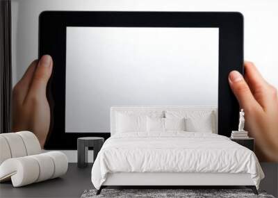 Hands holding a blank black tablet, fingers ready to interact with the empty screen, all isolated on a white background Wall mural