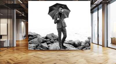  fashionable young man with umbrella standing near the sea Wall mural