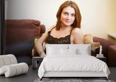 attractive woman relaxing on sofa Wall mural