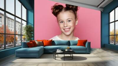 Cute girl 7-8 year old posing in studio over pink background Wall mural