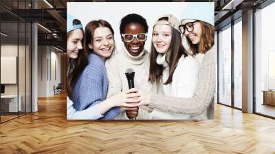 diverse multi nation girls group, teenage friends company cheerful having fun with microphone Wall mural