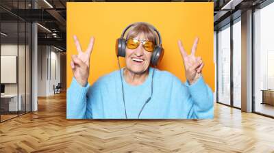 Funny old lady listening music and showing thumbs up.  Wall mural