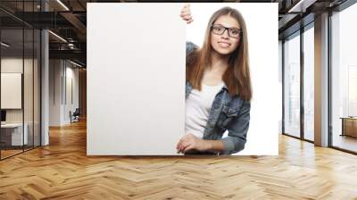 Gorgeous woman wearing glasses pointing at a board while standin Wall mural