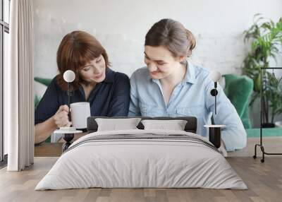 mother and adult daughter using tablet computer at home Wall mural